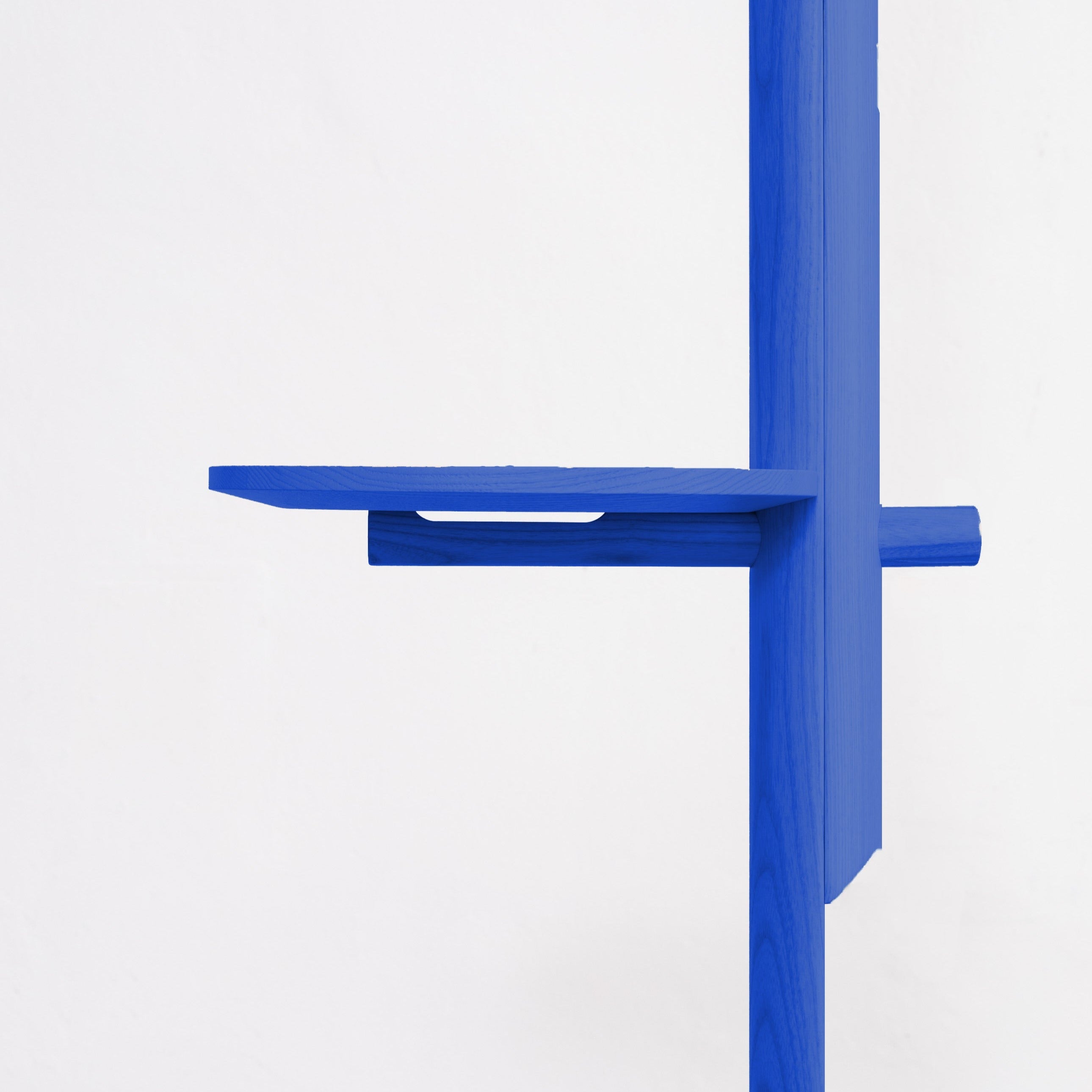Minimalist blue wooden shelf with a flat horizontal platform and vertical support panel.