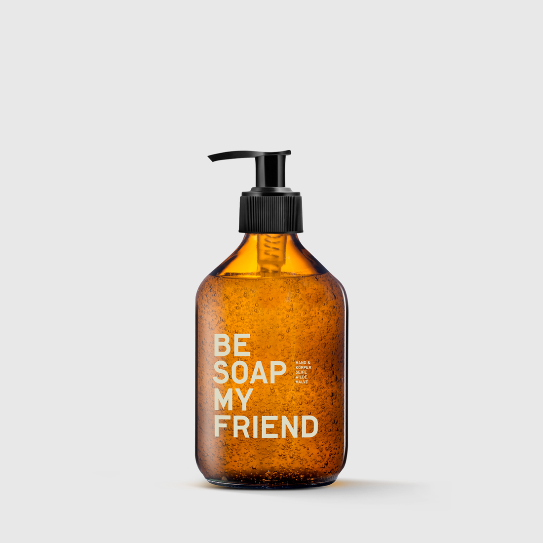 Amber glass pump bottle with black dispenser labeled "BE SOAP MY FRIEND" in white text.