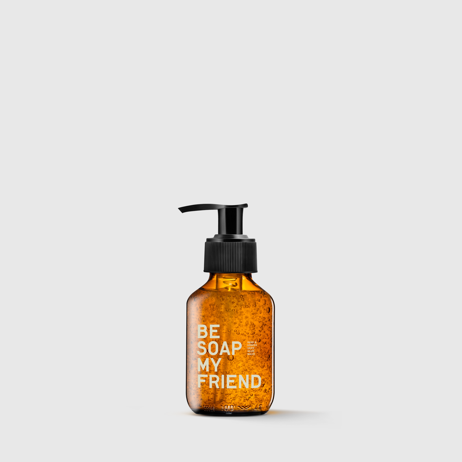Amber pump bottle with black dispenser labeled "BE SOAP MY FRIEND" containing liquid soap.