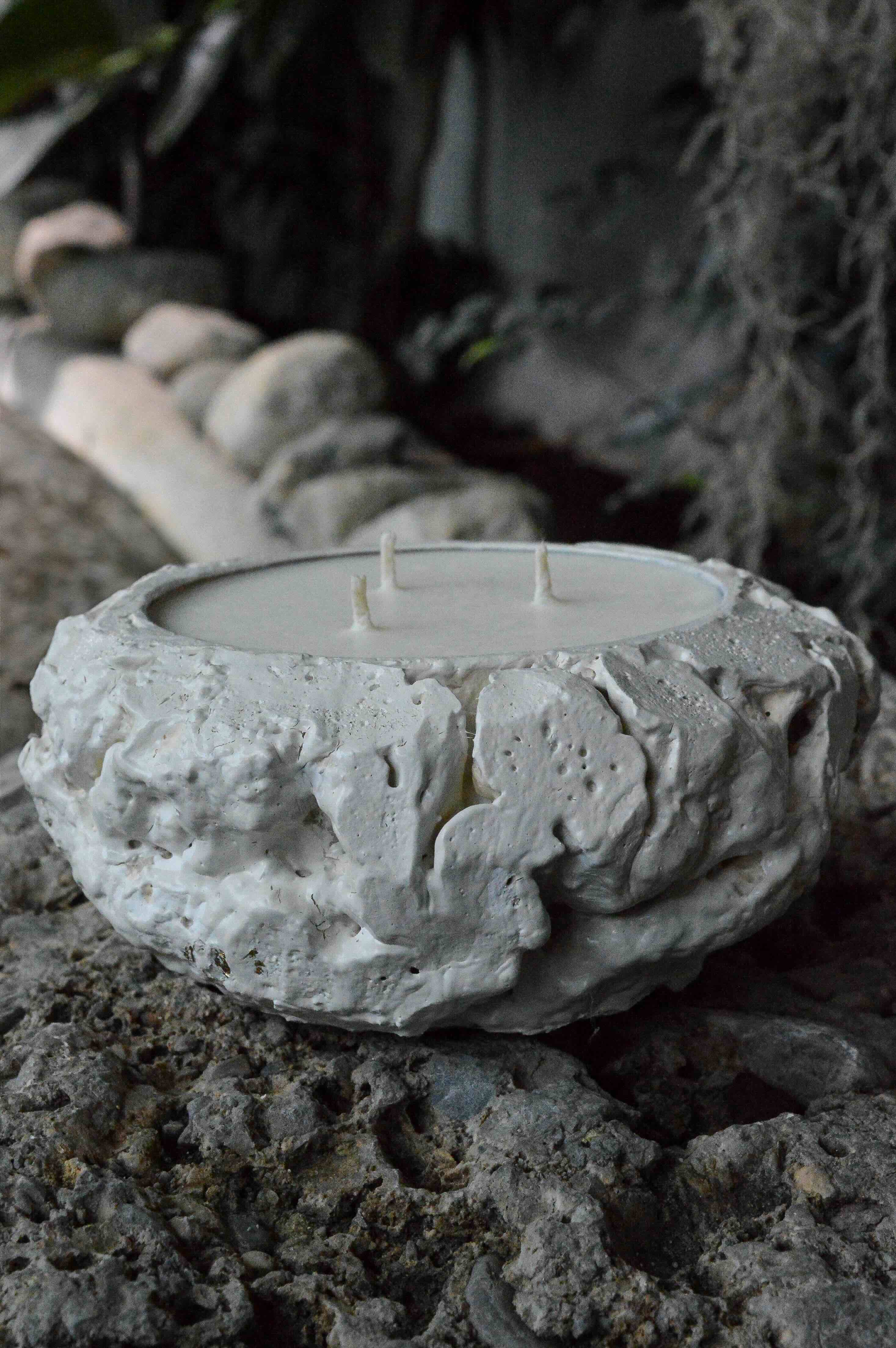 White textured ceramic candle holder with two unlit wicks and organic, uneven surface design.