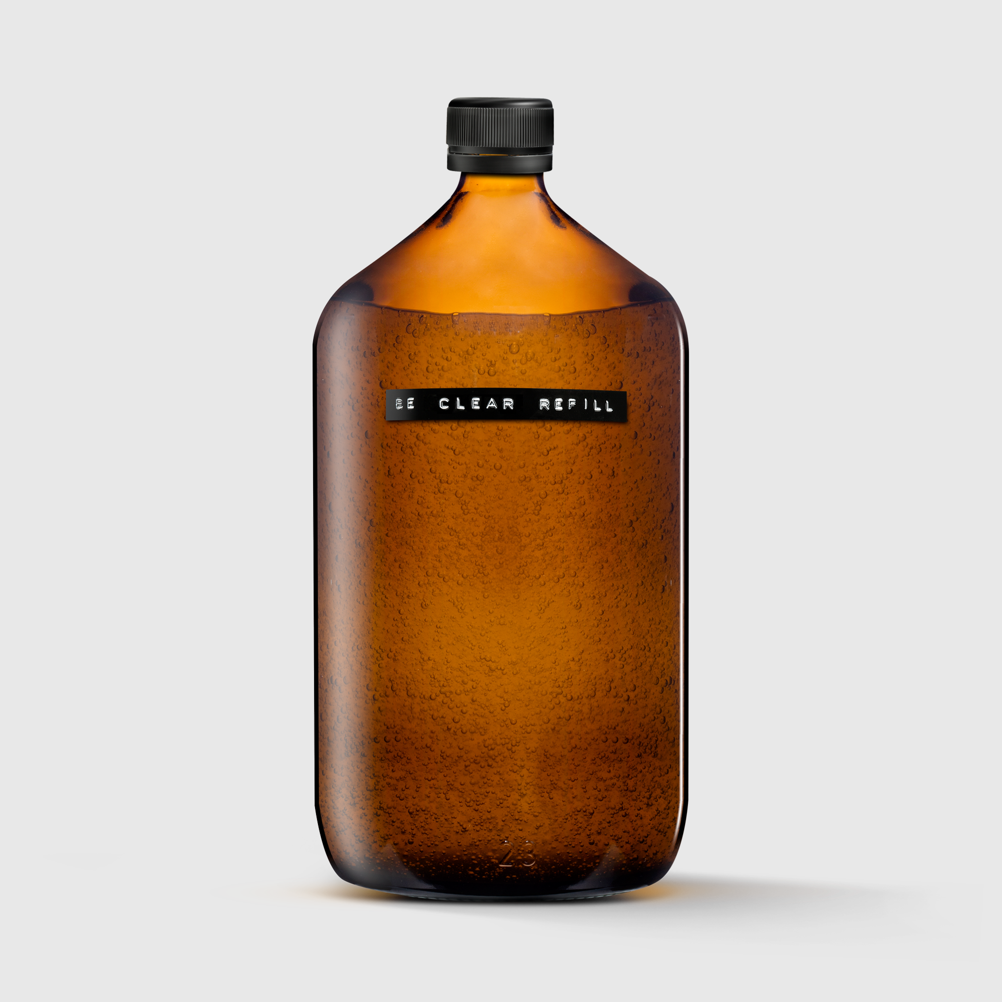 Amber glass refill bottle with black cap and label reading "RE CLEAR REFILL".
