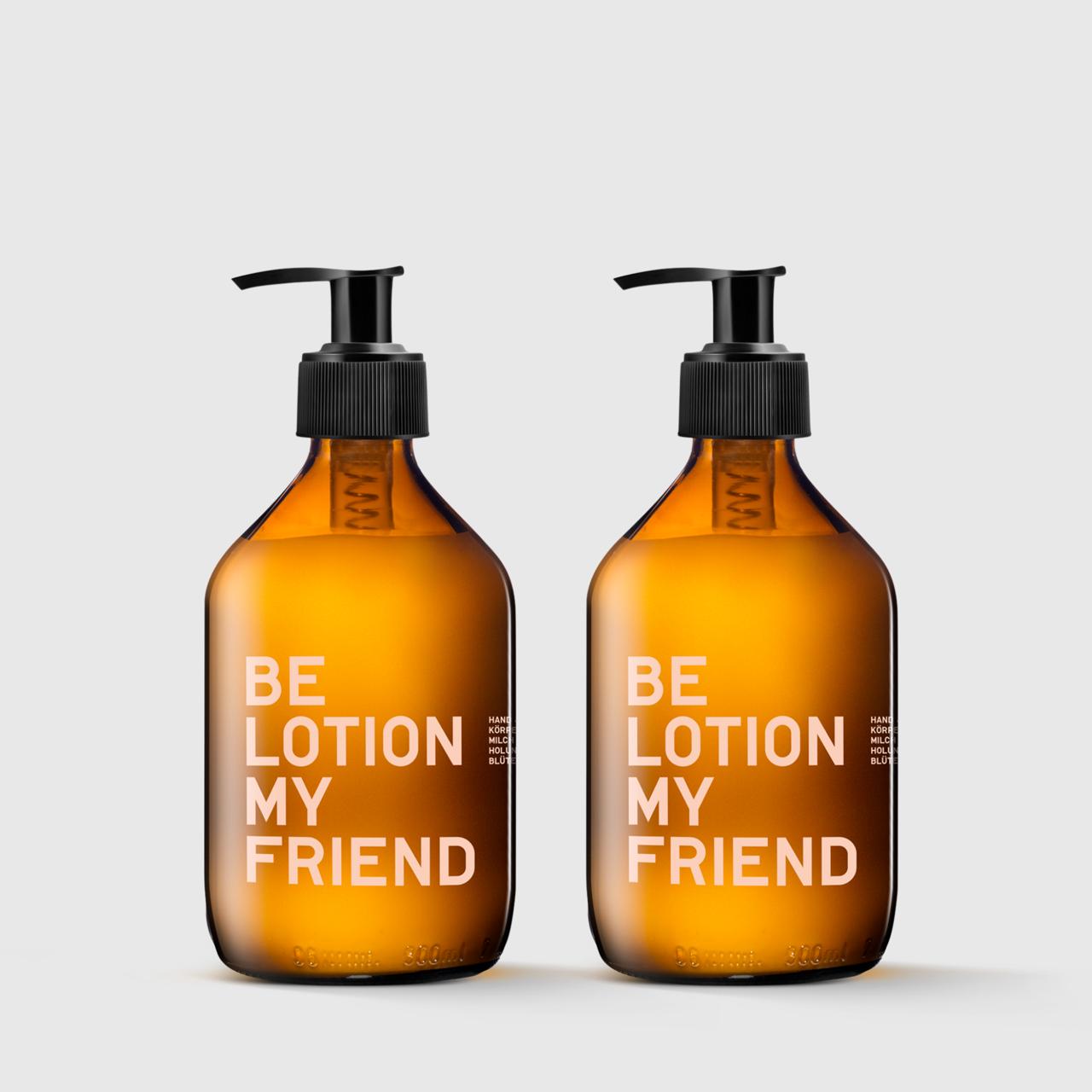 Two amber glass pump bottles labeled "BE LOTION MY FRIEND" with black dispensers on a light gray background.
