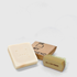 Natural beige soap bar with embossed logo next to wooden hand brush with bristles and "BE L.I.