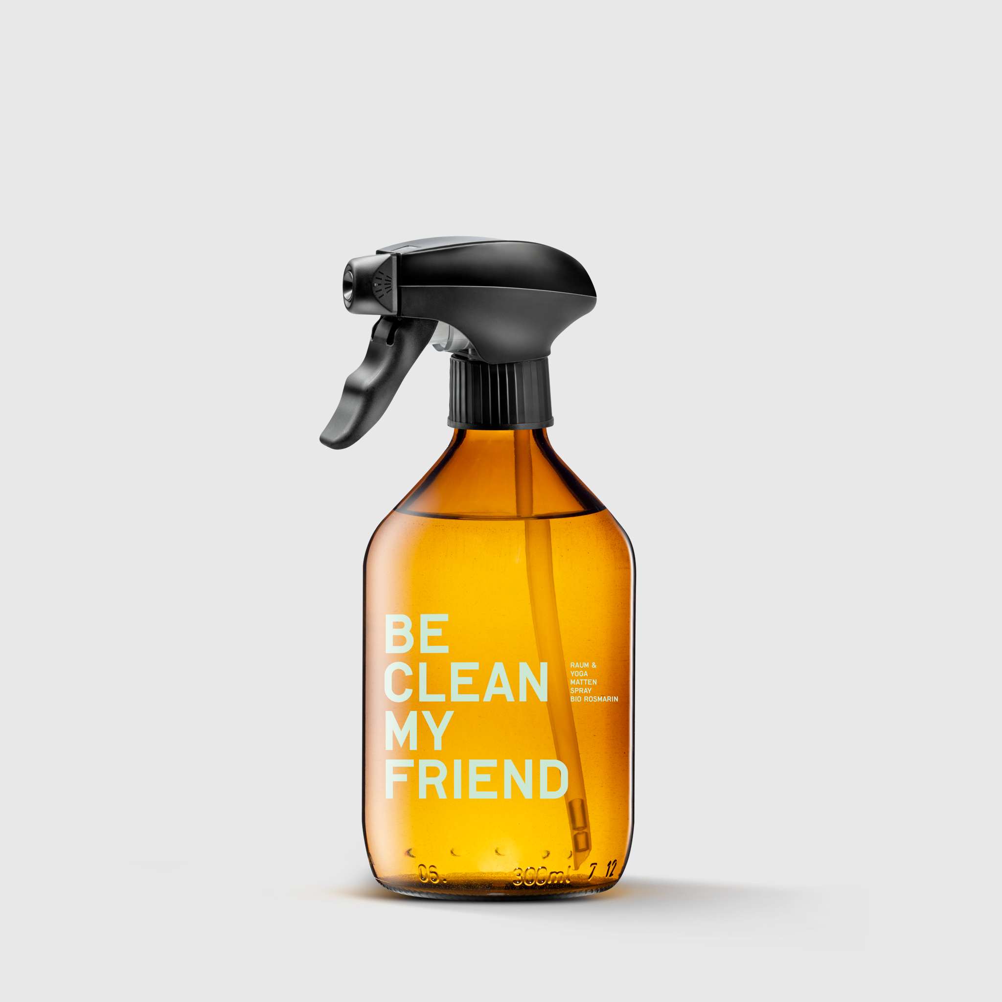 Amber glass spray bottle with black trigger top and white "Be Clean My Friend" text label.
