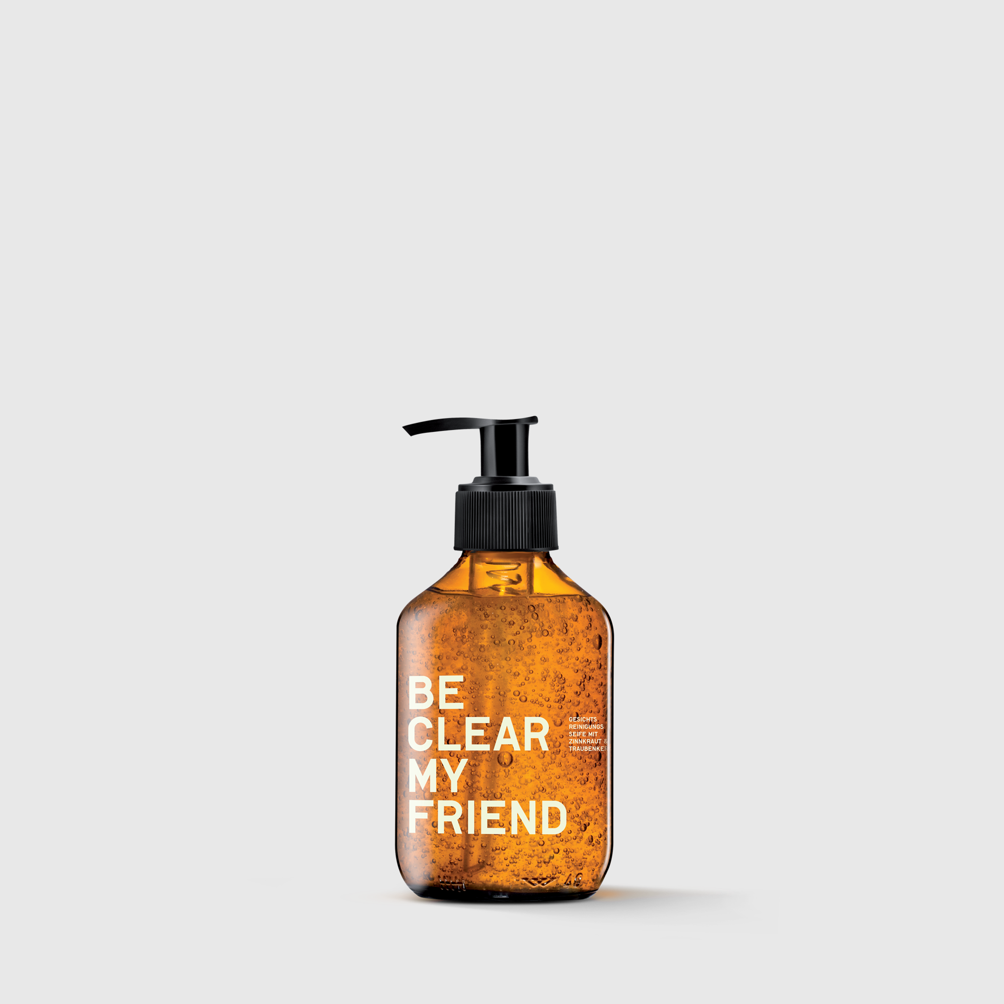 Amber plastic pump bottle with white text "BE CLEAR MY FRIEND" containing face soap with horsetail extract.