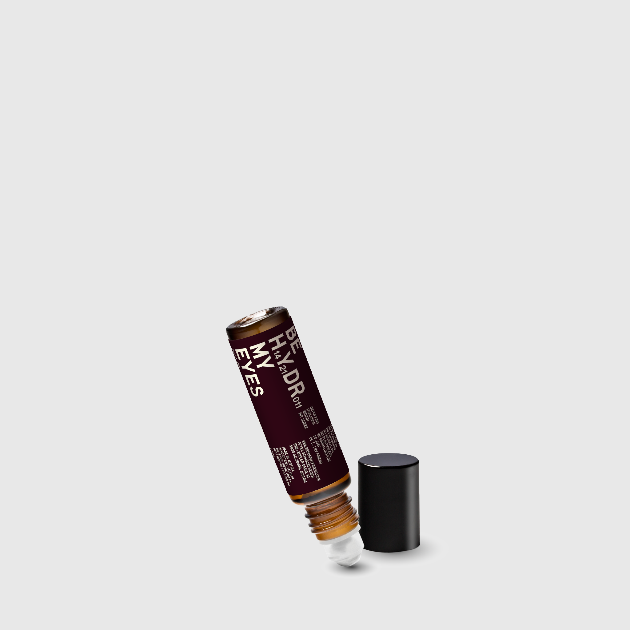 10ml amber glass roll-on bottle of Hyaluron eye serum with cucumber, black cap removed.