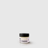 Small round white candle jar with black lid and gold text "BE KISSED MY FRIEND" on the label.
