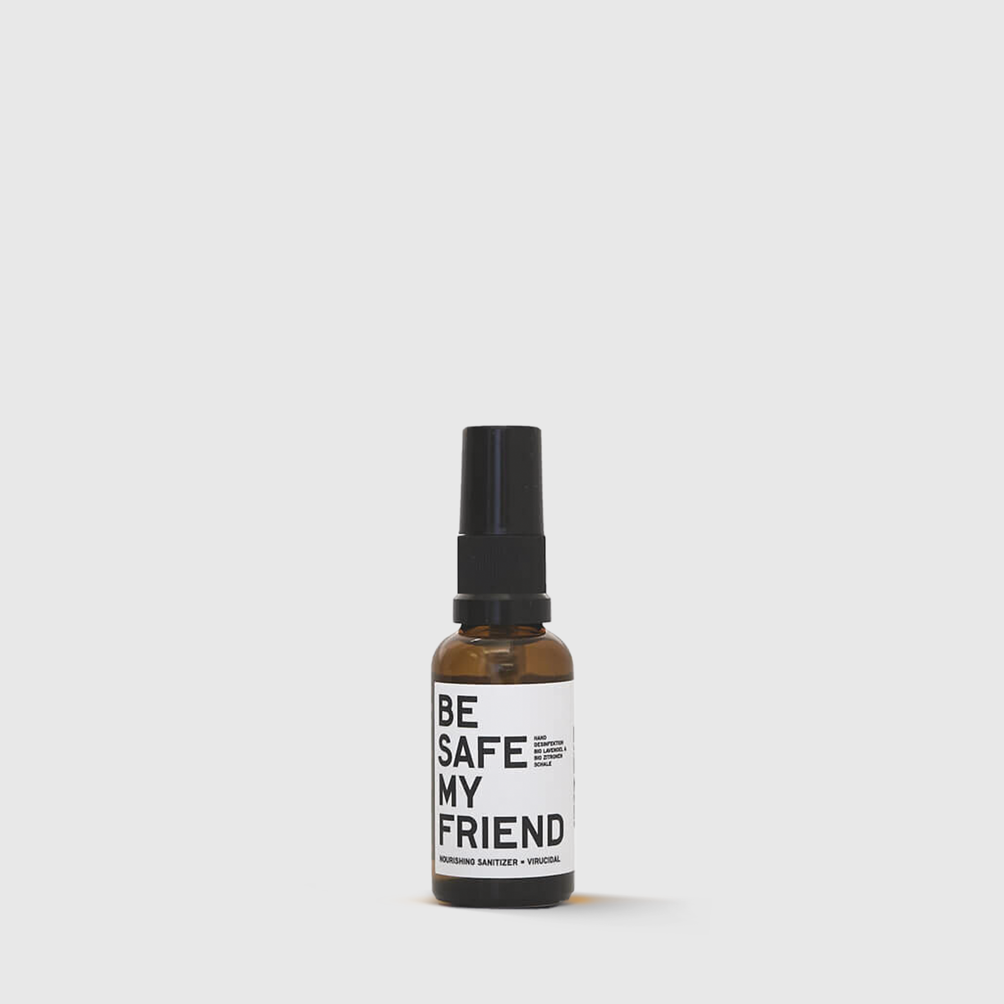 Amber glass bottle with black pump and white label that reads "Be Safe My Friend".