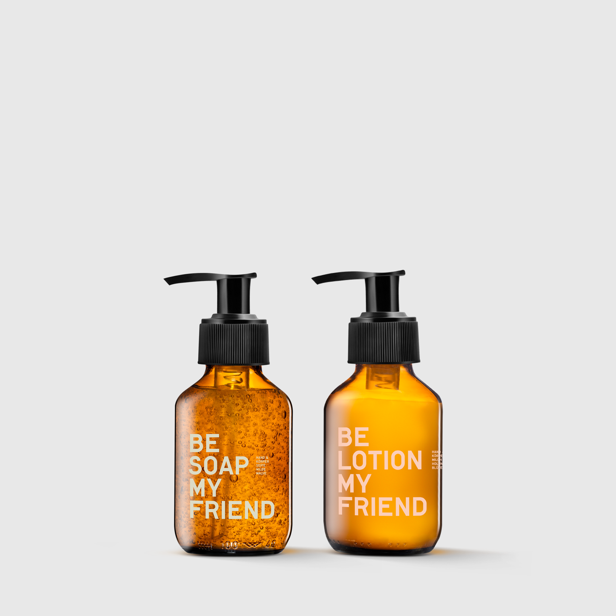 Amber glass pump bottles labeled "Be Soap My Friend" and "Be Lotion My Friend" on a white background.