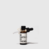 Amber glass dropper bottle with black cap and white label reading "Be Earth My Friend".
